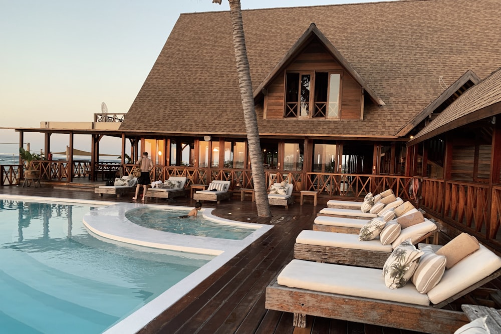 A resort poolside deck at dusk, representing curated hotel and dining privileges
