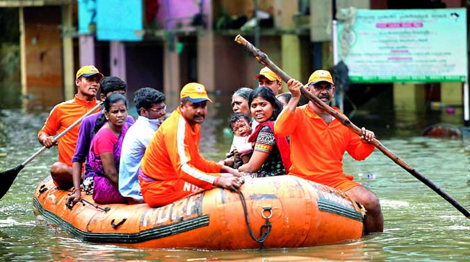 National Disaster Response Force (NDRF) personnel rescue people stranded in floodwaters in Chennai on Friday. Though the rain eased on Friday, the misery of tens of thousands of people was far from over, with large parts of the main city still under National Disaster Response Force (NDRF) personnel rescue people stranded in floodwaters in Chennai on Friday. Though the rain eased on Friday, the misery of tens of thousands of people was far from over, with large parts of the main city still under