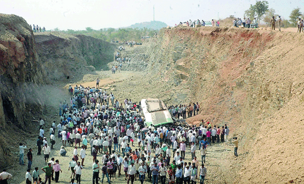 People surround the RTC bus which fell into a gorge on Wednesday morning near Penukonda of Anantapur district. People surround the RTC bus which fell into a gorge on Wednesday morning near Penukonda of Anantapur district.