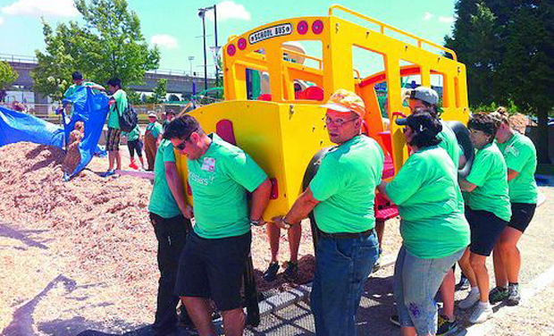 Kaboom! volunteers install machinery for a community play ground. Kaboom! volunteers install machinery for a community play ground.