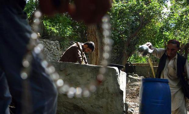 A local resident pours the juice from crushed grapes as part of a brewing wine process in a garden in the remote village of Sher Qilla in Punyal valley in northern Pakistan. (Photo: AFP) A local resident pours the juice from crushed grapes as part of a brewing wine process in a garden in the remote village of Sher Qilla in Punyal valley in northern Pakistan. (Photo: AFP)