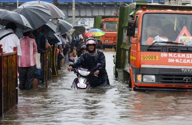 A two wheeler rider pushes her vehicle in waist deep water. Heavy showers and high tides brought Mumbai to a standstill on June 19, 2015 (Photo: Deccan Chronicle/Rajesh Jadhav) A two wheeler rider pushes her vehicle in waist deep water. Heavy showers and high tides brought Mumbai to a standstill on June 19, 2015 (Photo: Deccan Chronicle/Rajesh Jadhav)