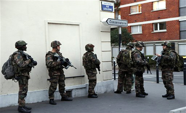 Soldiers operate in Saint-Denis, a northern suburb of Paris, Wednesday, Nov. 18, 2015. Soldiers operate in Saint-Denis, a northern suburb of Paris, Wednesday, Nov. 18, 2015.