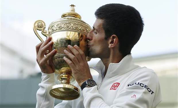 Novak Djokovic of Serbia kisses the trophy after defeating Roger Federer of Switzerland in the men's singles final match at the All England Lawn Tennis Championships in Wimbledon. Photo: AP Novak Djokovic of Serbia kisses the trophy after defeating Roger Federer of Switzerland in the men's singles final match at the All England Lawn Tennis Championships in Wimbledon. Photo: AP