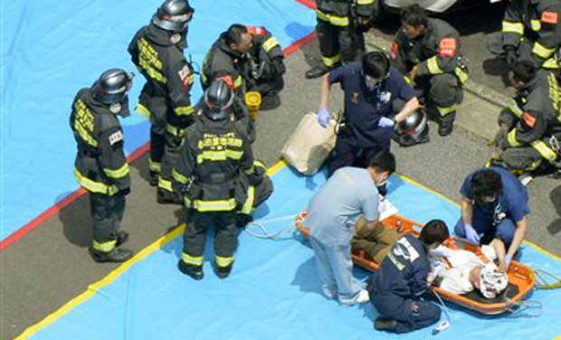 Passengers of a Shinkansen bullet train which made an emergency stop, receive treatment in Odawara, west of Tokyo Tuesday, June 30, 2015. A passenger on the Japan's high-speed bullet train tried to set himself or herself on fire Tuesday, causing Passengers of a Shinkansen bullet train which made an emergency stop, receive treatment in Odawara, west of Tokyo Tuesday, June 30, 2015. A passenger on the Japan's high-speed bullet train tried to set himself or herself on fire Tuesday, causing