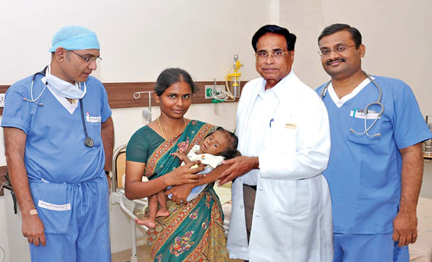 Dr Prashant Vaijayanth, director, cardiothoracic surgeon, Dr Deva Prasath, paediatric cardiologist and chairman of KMCH, Dr Nalla G. Palanisamy are seen with Baby Krishna (Photo:DC/File) Dr Prashant Vaijayanth, director, cardiothoracic surgeon, Dr Deva Prasath, paediatric cardiologist and chairman of KMCH, Dr Nalla G. Palanisamy are seen with Baby Krishna (Photo:DC/File)