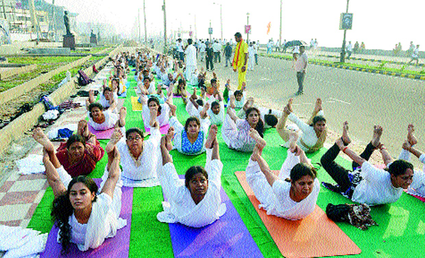Women do yoga on the RK Beach road in Visakhapatnam (Photo: DC) Women do yoga on the RK Beach road in Visakhapatnam (Photo: DC)