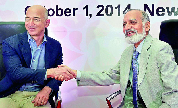 Amazon.com founder and CEO Jeff Bezos (left) shakes hands with Kiran Karnik, former president of Indian IT industry body Nasscom at a Ficci meeting in New Delhi on Wednesday (Photo: PTI) Amazon.com founder and CEO Jeff Bezos (left) shakes hands with Kiran Karnik, former president of Indian IT industry body Nasscom at a Ficci meeting in New Delhi on Wednesday (Photo: PTI)