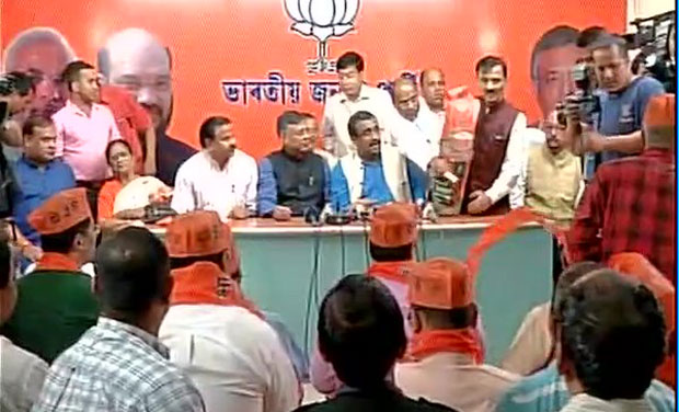 The nine legislators joined BJP at a special function in its state head office attended by the party's national general secretary Ram Madhav, state unit president Sidhartha Bhattacharjee, Himanta and other party leaders. (Photo: ANI/Twitter) The nine legislators joined BJP at a special function in its state head office attended by the party's national general secretary Ram Madhav, state unit president Sidhartha Bhattacharjee, Himanta and other party leaders. (Photo: ANI/Twitter)
