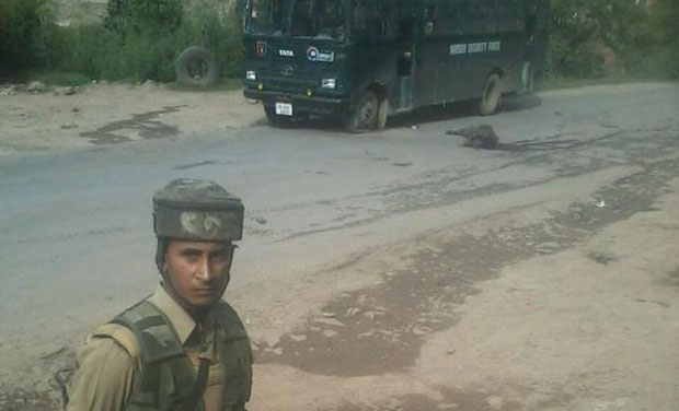 Body of a BSF jawan killed in encounter lying on the road (Photo: ANI Twitter) Body of a BSF jawan killed in encounter lying on the road (Photo: ANI Twitter)