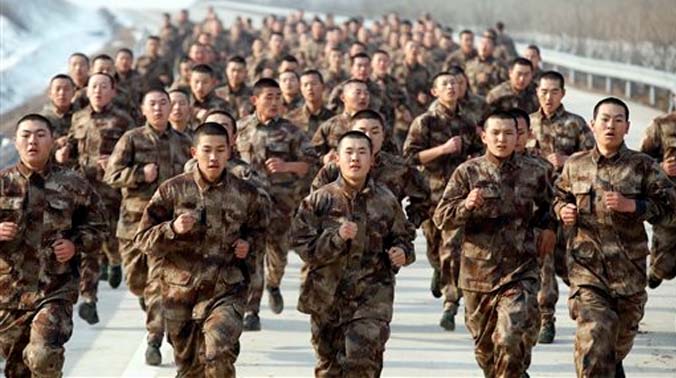 Novice soldiers run along a road during a test of military skills in Heihe in northeastern China's Heilongjiang province. China has created three new military units as part of reforms to modernize its military and improve its fighting capacity. ( Novice soldiers run along a road during a test of military skills in Heihe in northeastern China's Heilongjiang province. China has created three new military units as part of reforms to modernize its military and improve its fighting capacity. (