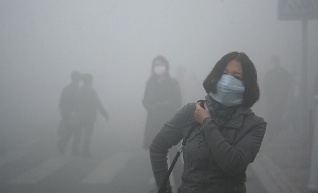 A woman wearing a mask walks through a street covered by dense smog in Harbin, northern China. Visibility shrank to less than half a football field and small-particle pollution soared to a record 40 times higher than an international safety standard A woman wearing a mask walks through a street covered by dense smog in Harbin, northern China. Visibility shrank to less than half a football field and small-particle pollution soared to a record 40 times higher than an international safety standard