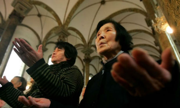 A Catholic church service in Beijing. There are between 8 and 12 million Catholics in China, about half of whom worship in underground congregations. Photo- AP
A Catholic church service in Beijing. There are between 8 and 12 million Catholics in China, about half of whom worship in underground congregations. Photo- AP