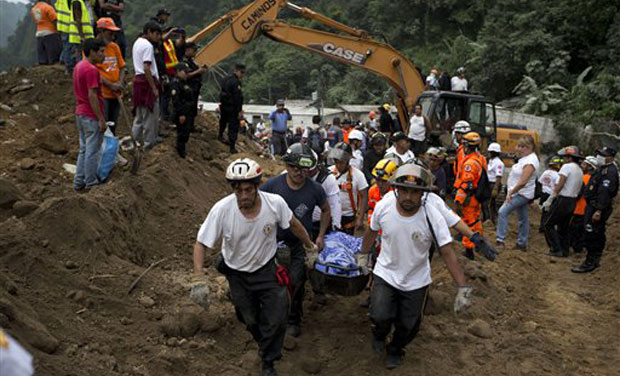Rescuers carry a body recovered from the site of a landslide in Cambray, a neighborhood in the suburb of Santa Catarina Pinula, about 10 miles east of Guatemala City. (Photo: AP) Rescuers carry a body recovered from the site of a landslide in Cambray, a neighborhood in the suburb of Santa Catarina Pinula, about 10 miles east of Guatemala City. (Photo: AP)