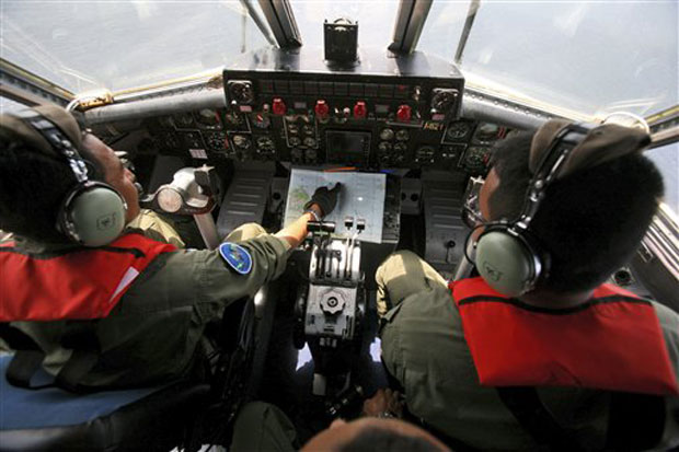 Indonesian Navy pilots Maj. Bambang Edi Saputro, left, and 2nd Lt. Tri Laksono check their map during a search operation for the missing Malaysian Airlines Boeing 777 over the waters bordering Indonesia, Malaysia and Thailand. Photo -AP Indonesian Navy pilots Maj. Bambang Edi Saputro, left, and 2nd Lt. Tri Laksono check their map during a search operation for the missing Malaysian Airlines Boeing 777 over the waters bordering Indonesia, Malaysia and Thailand. Photo -AP
