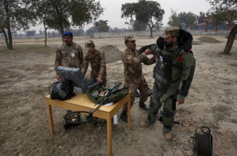 A soldier helps his colleague to put on an armoured suit for a training session at the Counter IED Explosives and Munitions School in Risalpur. File photo - AP A soldier helps his colleague to put on an armoured suit for a training session at the Counter IED Explosives and Munitions School in Risalpur. File photo - AP