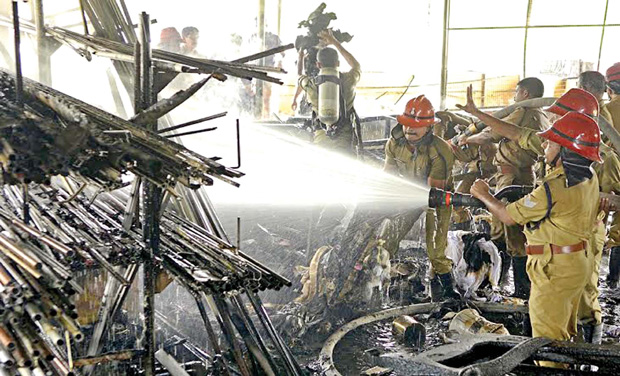 Fire force personnel trying to extinguish the fire that broke out at a godown-cum-shop of mattresses housed at LIC Complex in Karmana on Saturday. (Photo: AV MUZAFAR) Fire force personnel trying to extinguish the fire that broke out at a godown-cum-shop of mattresses housed at LIC Complex in Karmana on Saturday. (Photo: AV MUZAFAR)