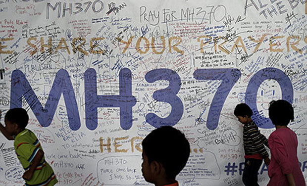 Children run past dedication messages put up for the missing Malaysia Airlines MH 370 plane on the walls of Kuala Lumpur airport. Photo- AP Children run past dedication messages put up for the missing Malaysia Airlines MH 370 plane on the walls of Kuala Lumpur airport. Photo- AP