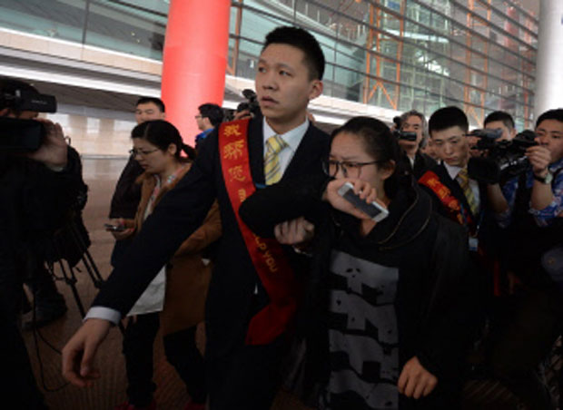 A crying woman is escorted to a bus for relatives at the Beijing Airport after news of the missing Malaysia Airlines Boeing 777-200. Photo- AFP A crying woman is escorted to a bus for relatives at the Beijing Airport after news of the missing Malaysia Airlines Boeing 777-200. Photo- AFP