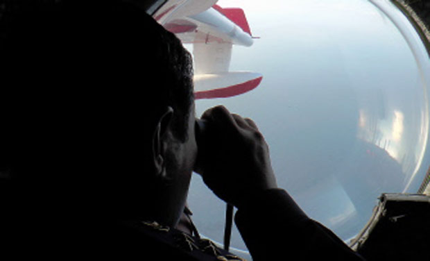 Malaysian Maritime Enforcement personnel looking through binoculars during search and rescue operations for the missing Malaysia Airlines (MAS) Boeing 777-200. Photo- AFP Malaysian Maritime Enforcement personnel looking through binoculars during search and rescue operations for the missing Malaysia Airlines (MAS) Boeing 777-200. Photo- AFP