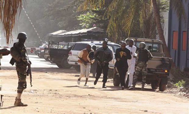 People run to flee from the Radisson Blu Hotel in Bamako, Mali where assailants have takenhostages in a brazen assault involving grenades. (Photo: AP) People run to flee from the Radisson Blu Hotel in Bamako, Mali where assailants have takenhostages in a brazen assault involving grenades. (Photo: AP)