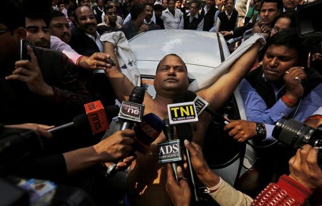 Manoj Sharma, lawyer from Gwalior, is surrounded by the media after he threw ink on Sahara Group chief Subrata Roy outside the Supreme Court on Tuesday. Photo- AP Manoj Sharma, lawyer from Gwalior, is surrounded by the media after he threw ink on Sahara Group chief Subrata Roy outside the Supreme Court on Tuesday. Photo- AP