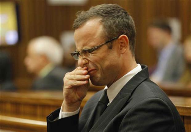 Oscar Pistorius rubs his face as he listens to cross questioning about the events surrounding the shooting death of his girlfriend Reeva Steenkamp, in court. Photo- AP Oscar Pistorius rubs his face as he listens to cross questioning about the events surrounding the shooting death of his girlfriend Reeva Steenkamp, in court. Photo- AP