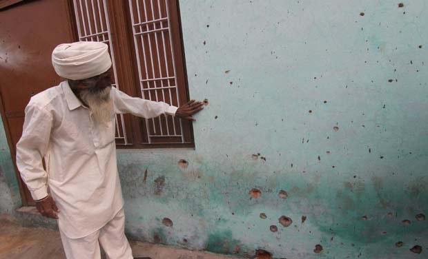 A villager shows bullet marks on the wall of his house after a firing from Pakistan side in Chanana village at the India-Pakistan International border at Arnia sector in Jammu (Photo: PTI) A villager shows bullet marks on the wall of his house after a firing from Pakistan side in Chanana village at the India-Pakistan International border at Arnia sector in Jammu (Photo: PTI)