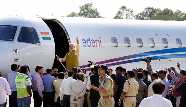 Prime Minister-designate Narendra Modi waves while boarding a flight for Delhi at the airport in Ahmedabad (Photo: PTI) Prime Minister-designate Narendra Modi waves while boarding a flight for Delhi at the airport in Ahmedabad (Photo: PTI)