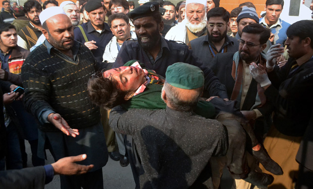 Hospital security guards carry a students injured in the shootout at a school under attacked by Taliban gunmen in Peshawar, Pakistan (Photo: AP) Hospital security guards carry a students injured in the shootout at a school under attacked by Taliban gunmen in Peshawar, Pakistan (Photo: AP)
