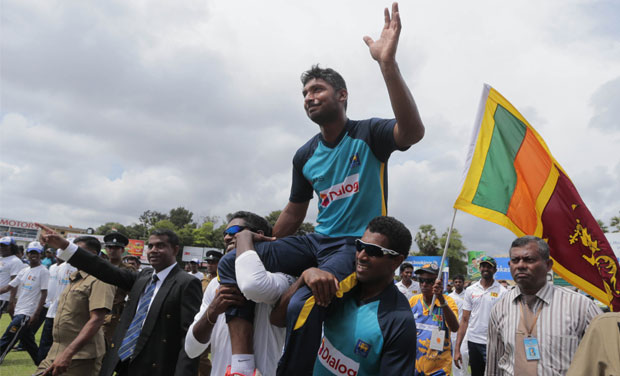Signing autographs and posing for pictures with the ground-staff while the presentation ceremony was on, Kumar Sangakkara grinned widely when a special ceremony began to honour his contribution to the game. (Photo: AP) Signing autographs and posing for pictures with the ground-staff while the presentation ceremony was on, Kumar Sangakkara grinned widely when a special ceremony began to honour his contribution to the game. (Photo: AP)
