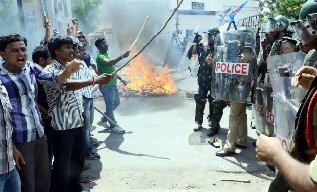 Police trying to stop pro-Telangana students of Osmania University who were protesting against the Seemandhra activists in Hyderabad. (Photo: PTI) Police trying to stop pro-Telangana students of Osmania University who were protesting against the Seemandhra activists in Hyderabad. (Photo: PTI)