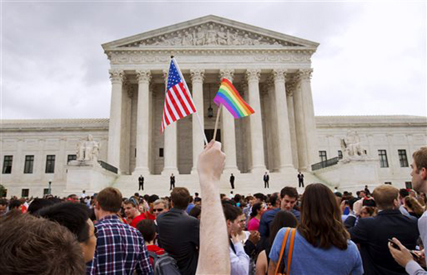 A man holds a U.S. and a rainbow flag outside the Supreme Court in Washington after the court legalized gay marriage nationwide. After the decision, religious conservatives are focusing on preserving their right to object. Their concerns are for the A man holds a U.S. and a rainbow flag outside the Supreme Court in Washington after the court legalized gay marriage nationwide. After the decision, religious conservatives are focusing on preserving their right to object. Their concerns are for the