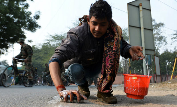 A worker employed by a local contractor scrubs the road to the Taj Mahal in Agra ahead of US President Barack Obama's visit. (Photo: AFP) A worker employed by a local contractor scrubs the road to the Taj Mahal in Agra ahead of US President Barack Obama's visit. (Photo: AFP)