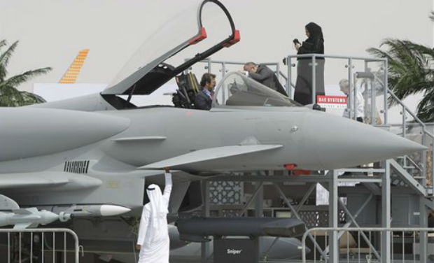 An Emirati woman, top right, and others view a replica of the Eurofighter Typhoon jet during the opening day of the Dubai Airshow in Dubai, United Arab Emirates on Sunday. AP An Emirati woman, top right, and others view a replica of the Eurofighter Typhoon jet during the opening day of the Dubai Airshow in Dubai, United Arab Emirates on Sunday. AP