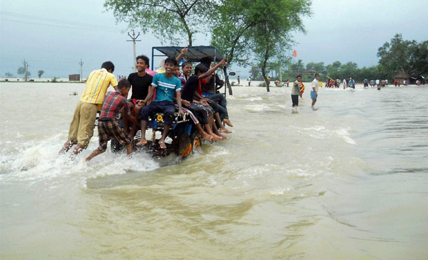 Locals wade through flood water at Karalaghat road in Burdwan district of West Bengal (Photo: PTI) Locals wade through flood water at Karalaghat road in Burdwan district of West Bengal (Photo: PTI)