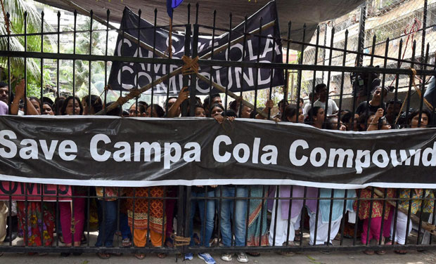 Campa Cola residents block the entrance for the BMC officials who arrived to disconnect the water and electricity supply of the society, in Mumbai. Photo: PTI Campa Cola residents block the entrance for the BMC officials who arrived to disconnect the water and electricity supply of the society, in Mumbai. Photo: PTI