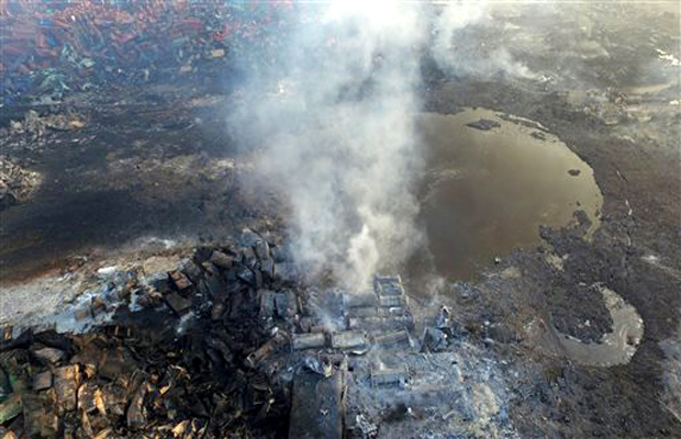 Smoke rises from debris near a crater that was at the center of a series of explosions in northeastern China's Tianjin municipality as seen from an aerial view. New explosions and fires rocked the Chinese port city of Tianjin on Saturday, as one Smoke rises from debris near a crater that was at the center of a series of explosions in northeastern China's Tianjin municipality as seen from an aerial view. New explosions and fires rocked the Chinese port city of Tianjin on Saturday, as one
