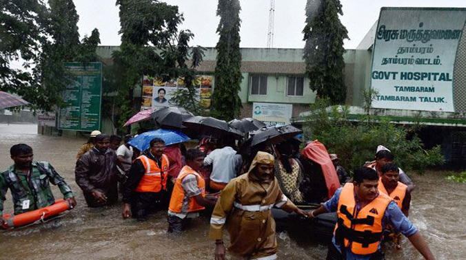 Rescuers shifting patients from a flooded hospital after heavy rains in Chennai on Tuesday. (Photo: PTI) Rescuers shifting patients from a flooded hospital after heavy rains in Chennai on Tuesday. (Photo: PTI)
