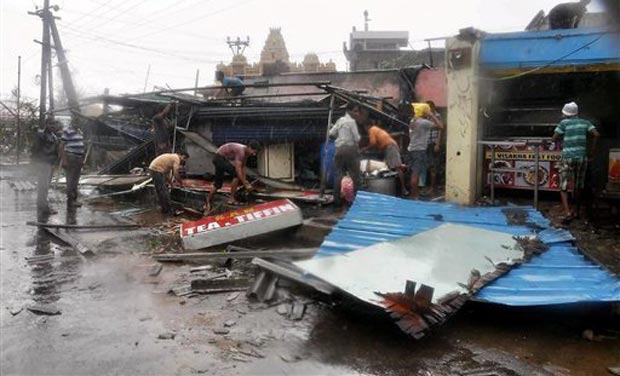 People sift through their damaged propery after Hudhud Cyclone in Vishakapatnam on Monday. (Photo: PTI) People sift through their damaged propery after Hudhud Cyclone in Vishakapatnam on Monday. (Photo: PTI)