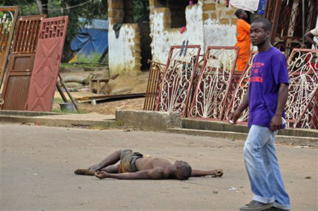 The lifeless body of a man lays unattended in the street as locals suspect him of dying from the deadly Ebola virus, as government warns the public not to leave Ebola victims in the streets in the city of Monrovia, Liberia, on Tuesday. (Photo: AP) The lifeless body of a man lays unattended in the street as locals suspect him of dying from the deadly Ebola virus, as government warns the public not to leave Ebola victims in the streets in the city of Monrovia, Liberia, on Tuesday. (Photo: AP)