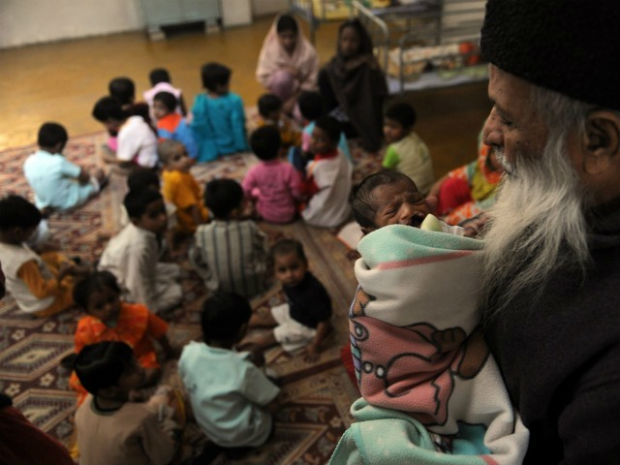 In this photograph taken on December 6, 2010 Abdul Sattar Edhi, head of Pakistani's Edhi foundation holds a disabled orphan at the orphanage of the charity in Karachi. (Photo: AFP) In this photograph taken on December 6, 2010 Abdul Sattar Edhi, head of Pakistani's Edhi foundation holds a disabled orphan at the orphanage of the charity in Karachi. (Photo: AFP)
