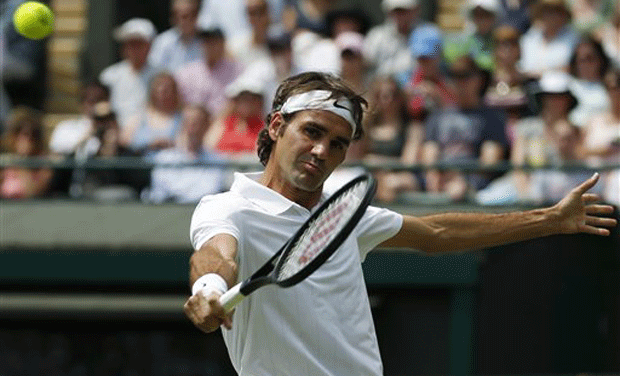 Roger Federer plays a return to Paolo Lorenzi during their first round match. (photo: AP) Roger Federer plays a return to Paolo Lorenzi during their first round match. (photo: AP)