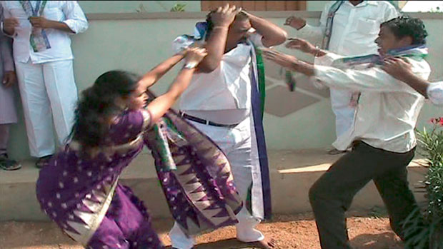 A woman YSRC leader Ganta Susheela (left) and her husband (right) are seen beating up YSRC district president Singireddy Bhaskar Reddy in Karimnagar on Thursday in this video clipping. (Photo: DC) A woman YSRC leader Ganta Susheela (left) and her husband (right) are seen beating up YSRC district president Singireddy Bhaskar Reddy in Karimnagar on Thursday in this video clipping. (Photo: DC)