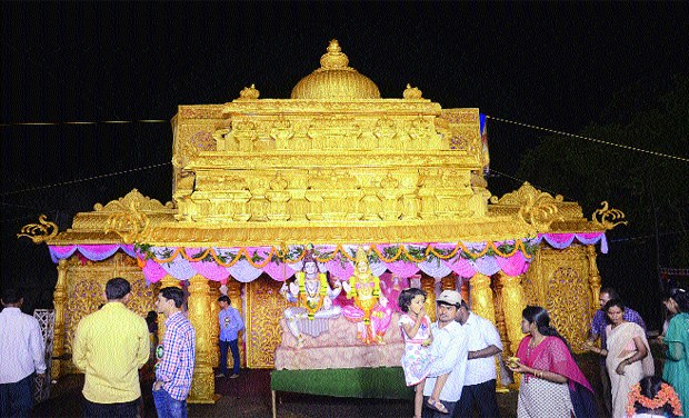 Devotees move past a pandal, a replica of a temple during Ganesh Puja celebrations behind Railway DRM office in Visakhapatnam on Saturday.(Photo: DECCAN CHRONICLE) Devotees move past a pandal, a replica of a temple during Ganesh Puja celebrations behind Railway DRM office in Visakhapatnam on Saturday.(Photo: DECCAN CHRONICLE)