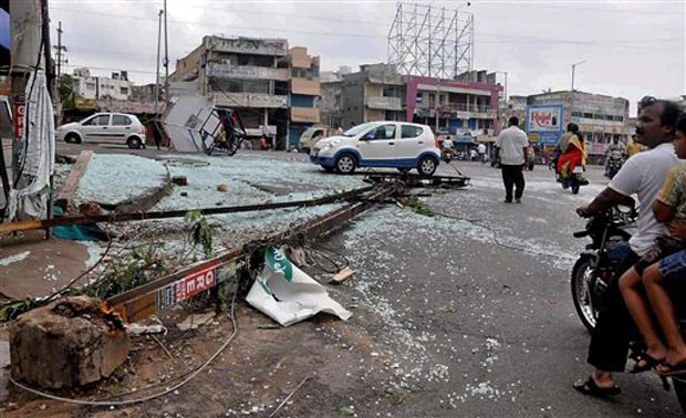 People watch damage after Hudhud Cyclone in Vishakapatnam on Monday. (Photo: PTI) People watch damage after Hudhud Cyclone in Vishakapatnam on Monday. (Photo: PTI)