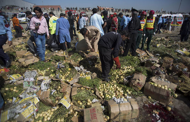 Pakistani investigators look for evidence at the spot of an explosion in Islamabad, Pakistan, on Wednesday. A bomb ripped through a fruit and vegetable market on the outskirts of the Pakistani capital of Islamabad on Wednesday morning, killing Pakistani investigators look for evidence at the spot of an explosion in Islamabad, Pakistan, on Wednesday. A bomb ripped through a fruit and vegetable market on the outskirts of the Pakistani capital of Islamabad on Wednesday morning, killing