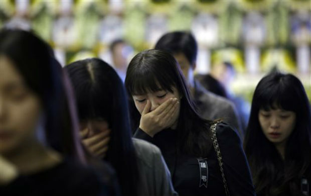 Mourners sob after paying tribute to the victims of the sunken ferry Sewol during a temporary memorial mainly for students from a local high school at the auditorium of the Olympic Memorial Museum in Ansan, south of Seoul, South Korea, on Thursday Mourners sob after paying tribute to the victims of the sunken ferry Sewol during a temporary memorial mainly for students from a local high school at the auditorium of the Olympic Memorial Museum in Ansan, south of Seoul, South Korea, on Thursday