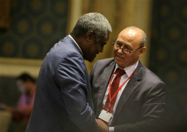 Libyan Foreign Minister Mohamed Abdelaziz, right, greets his Chadian counterpart Moussa Faki during the opening session of a gathering of foreign ministers of Libya's neighbors in Cairo, Egypt, Monday. (Photo: AP) Libyan Foreign Minister Mohamed Abdelaziz, right, greets his Chadian counterpart Moussa Faki during the opening session of a gathering of foreign ministers of Libya's neighbors in Cairo, Egypt, Monday. (Photo: AP)