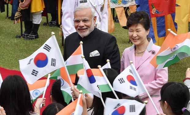 Prime Minister Narendra Modi with Korean President Park Geun-hye walks past children who were waving flags during his welcome ceremony at Grand Garden, Cheong wa Dae in Seoul. (Photo: AP) Prime Minister Narendra Modi with Korean President Park Geun-hye walks past children who were waving flags during his welcome ceremony at Grand Garden, Cheong wa Dae in Seoul. (Photo: AP)